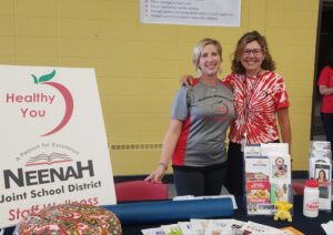 Jessica Lehman and Mary Shandonay smiling at a wellness booth
